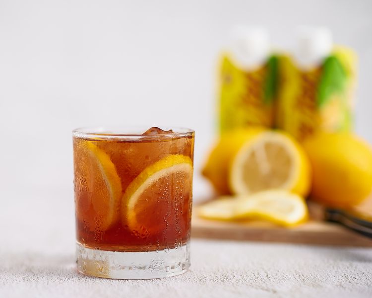 Iced hibiscus tea with lemon and mint garnish